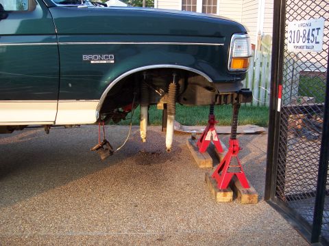 1992 Ford Bronco - Front suspension components removed from a 1992 Ford Bronco, supported by jack stands.