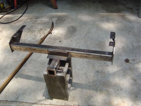 1986 Ford Bronco - A fabricated trailer hitch is shown resting on a concrete block.