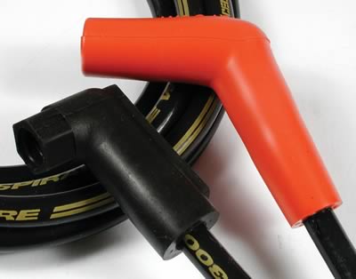 1990 Ford Bronco - Close-up of spark plug wires, showing black and orange boots and gold lettering on the cables.