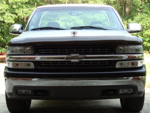 2002 Chevrolet Silverado 1500 - The front of a 2002 Chevrolet Silverado 1500 pickup truck is shown, its distinctive grille and headlights.