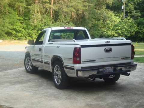 2002 Chevrolet Silverado 1500 - Rear view of a white 2002 Chevrolet Silverado 1500 pickup truck with chrome accents and a tonneau cover.