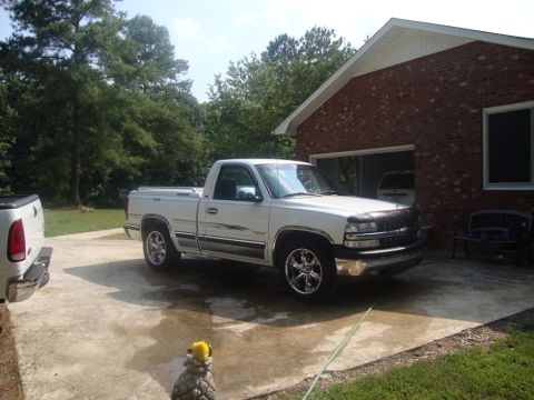 2002 Chevrolet Silverado 1500 - A white 2002 Chevrolet Silverado 1500 pickup truck is parked in a driveway.