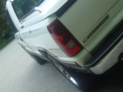 2002 Chevrolet Silverado 1500 - Rear view of a white Chevrolet Silverado pickup truck with a "SILVERADO" badge visible on the tailgate.