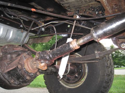 1979 Ford Bronco - Underside view of a vehicle's rear axle, driveshaft, and suspension components.