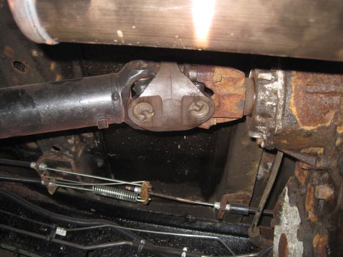 1979 Ford Bronco - Underside view of a vehicle's driveshaft and transmission components, showing wear and rust.