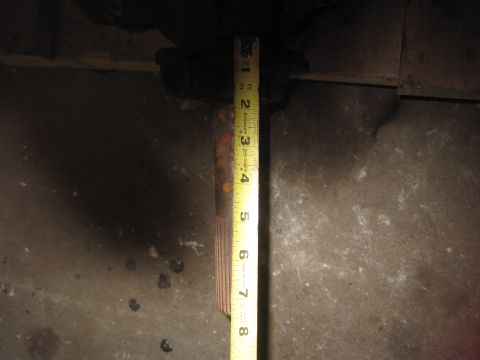 1979 Ford Bronco - A tape measure is used to gauge the diameter of a metal shaft.