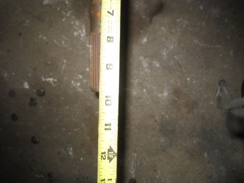 1979 Ford Bronco - A measuring tape is shown next to a splined shaft, likely for a transmission component.