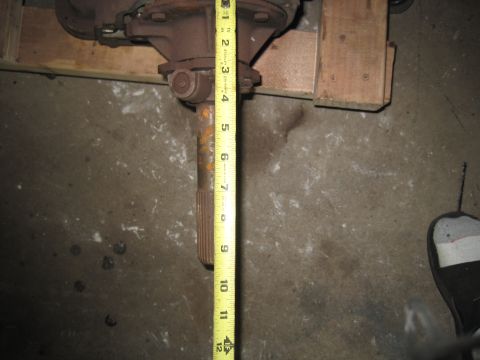 1979 Ford Bronco - Close-up of a differential housing with a measuring tape indicating its size.