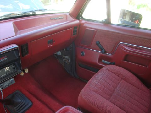 1989 Ford Bronco - Interior view of a 1989 Ford Bronco, red upholstery and dashboard trim with the model name visible.