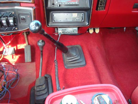 1989 Ford Bronco - Center console of a 1989 Ford Bronco, dual gear shifters and a CB radio.