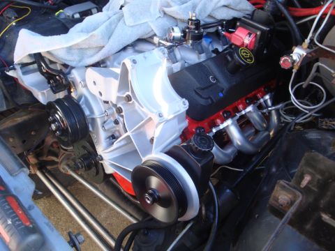 1989 Ford Bronco - Engine bay shot showing a Ford V8 engine with red valve covers and silver headers.