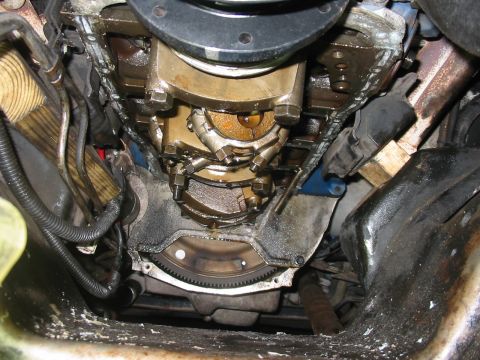 1992 Ford Bronco - Close-up view of an engine's oil pan and crankshaft, revealing internal components and signs of use.