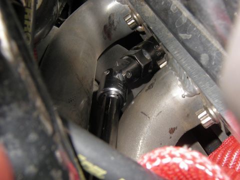 1990 Ford Bronco - A socket wrench is attached to a universal joint, likely for maintenance or repair work on a vehicle component.