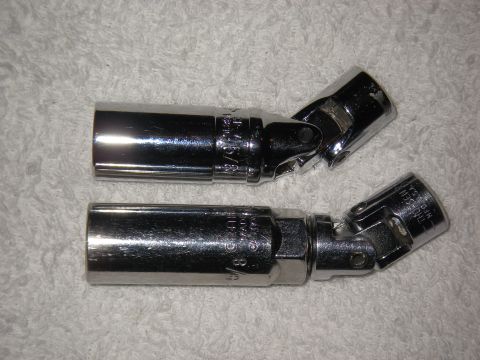 1990 Ford Bronco - Two universal joint spark plug sockets are shown on a white textured background.