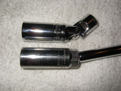 1990 Ford Bronco - Close-up of two chrome spark plug sockets, one with a universal joint, resting on a white towel.