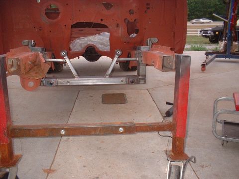 1964 Ford Fairlane - Vehicle frame is mounted on a stand for repair or restoration work.