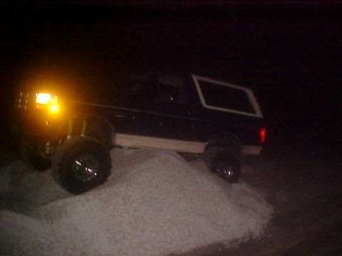 1996 Ford Bronco - 1996 Ford Bronco navigates a mound of white material in the dark.