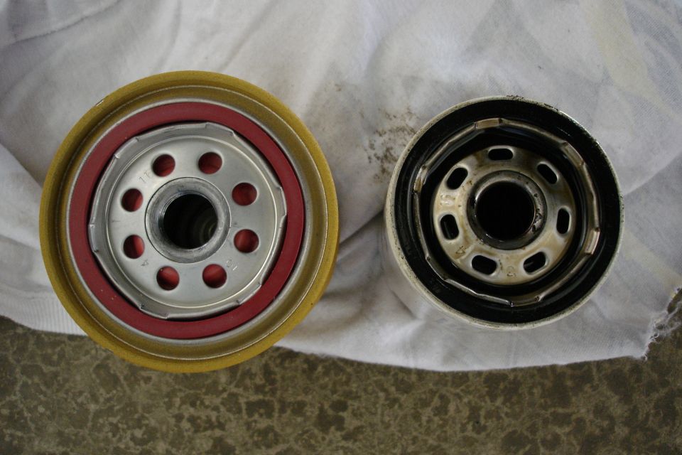 New oil filter next to a used oil filter