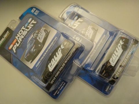 1993 Ford Taurus - Multiple toy Ford Police Interceptor models are displayed in their original packaging, with one clearly marked as a 2012 model.