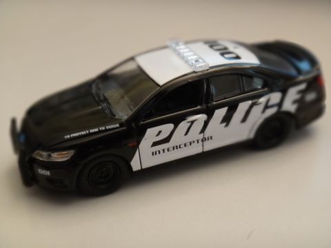 1993 Ford Taurus - A black and white police car with "POLICE INTERCEPTOR" text on the side is shown from a three-quarter front view.