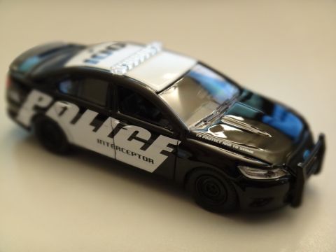 1993 Ford Taurus - A close-up view of a toy police car, detailed with markings and a light bar.