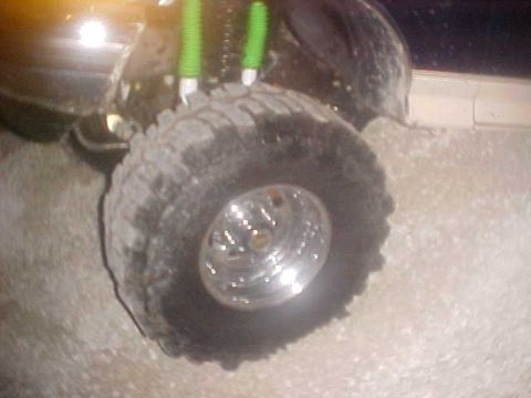 1996 Ford Bronco - Close-up of a vehicle's tire and suspension system, suggesting off-road use.