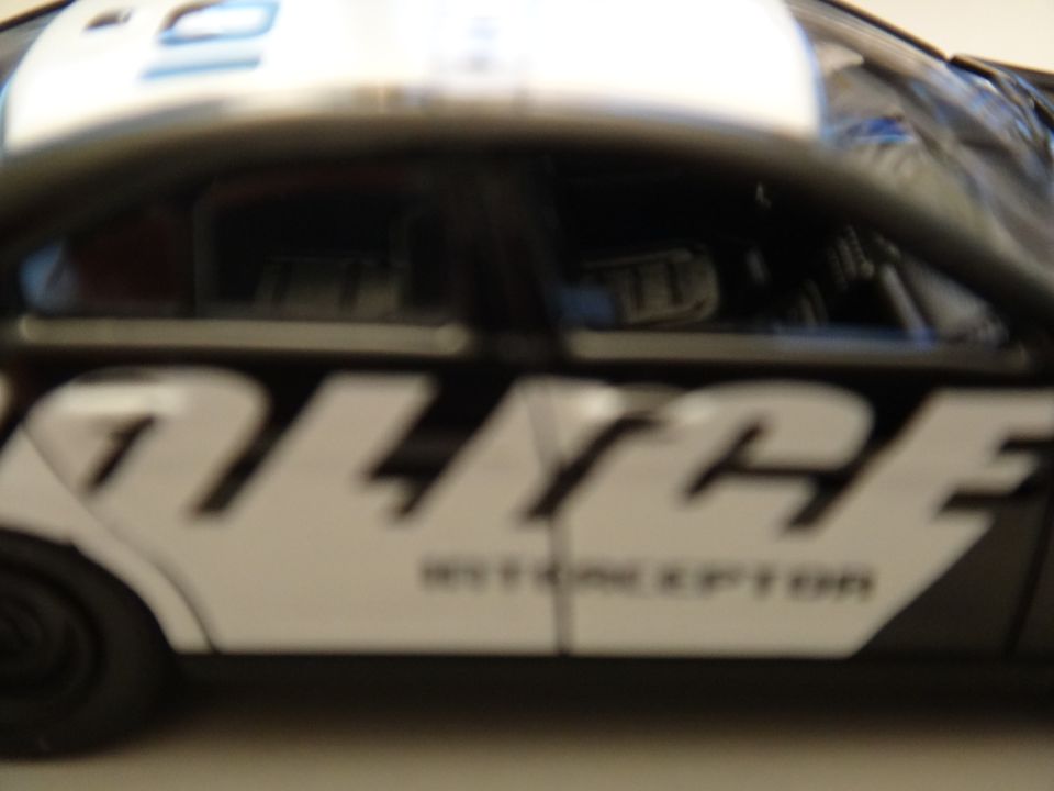 Side view of a police car with "POLICE INTERCEPTOR" text