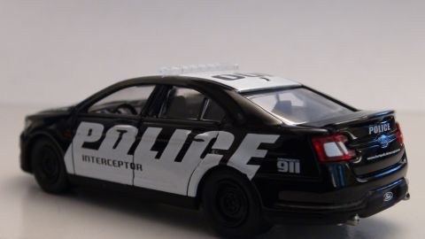 1993 Ford Taurus - This police car model features "POLICE INTERCEPTOR" branding and emergency lights on the roof.