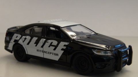 1993 Ford Taurus - Toy police car with 'POLICE INTERCEPTOR' text and a push bar.