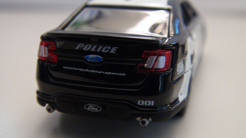 Black Ford Police Interceptor Utility rear with POLICE text and website www.fordpoliceinterceptor.com