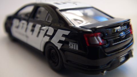 1993 Ford Taurus - Rear view of a toy police car with Ford badging and 'POLICE' text.