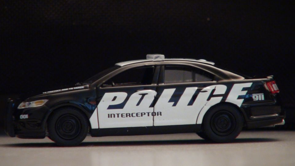toy police car with 'POLICE INTERCEPTOR' on the side