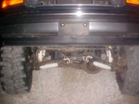 1996 Ford Bronco - Close-up view of a truck's rear axle and suspension system.