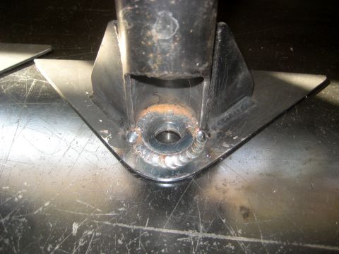 1996 Ford Bronco - This fabricated bracket features a central hole and welded supports, designed for undercarriage protection.
