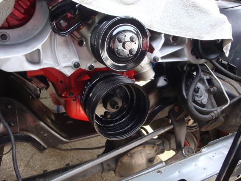 1989 Ford Bronco - Close-up view of engine pulleys and suspension components, with a white cloth covering part of the engine.