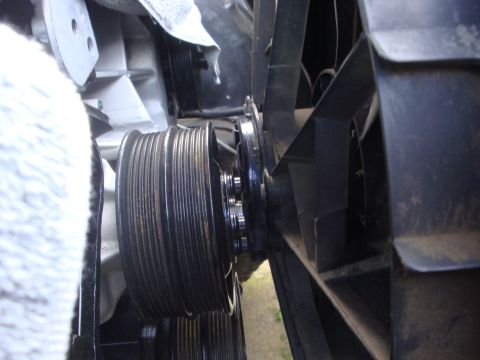 1989 Ford Bronco - Close-up view of engine pulleys and fan blades.