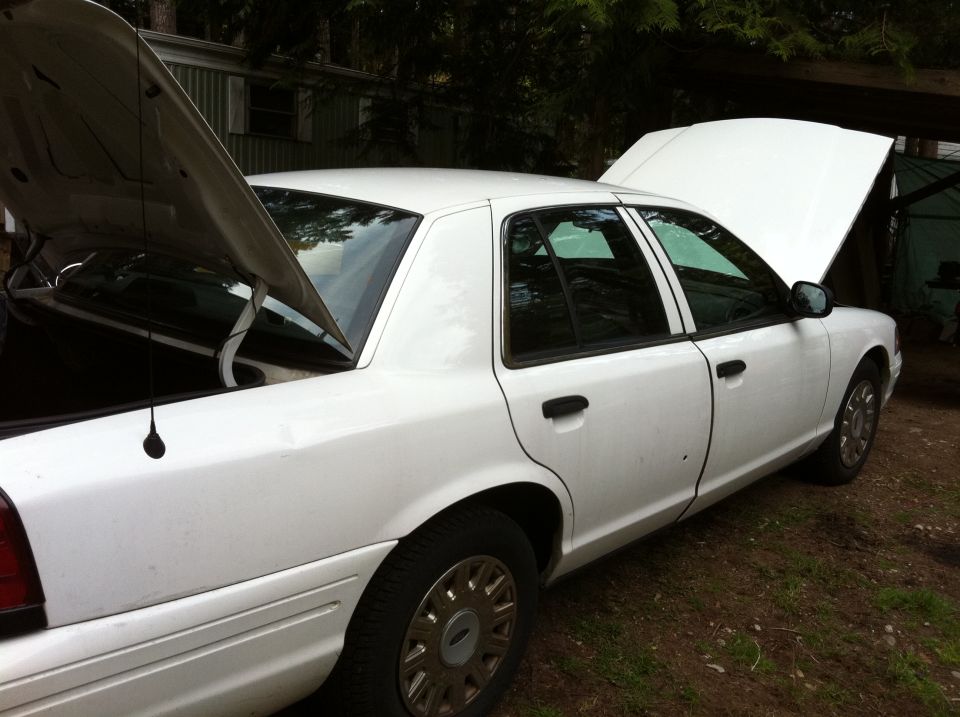 2005 Ford Crown Victoria with hood and trunk open, parked outdoors