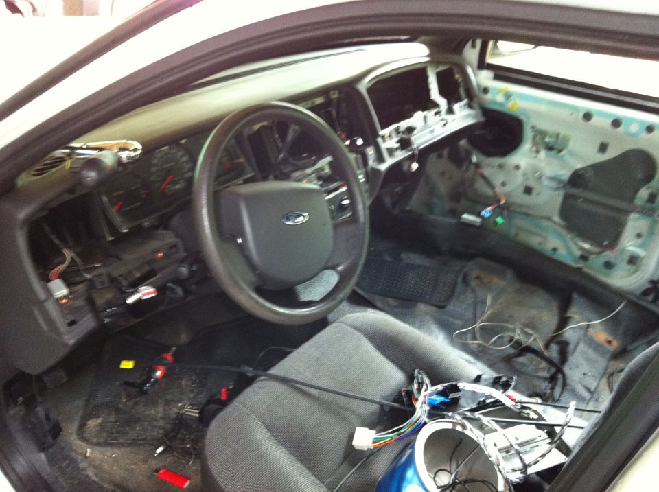 Stripped Ford Crown Victoria interior during a wiring or stereo install