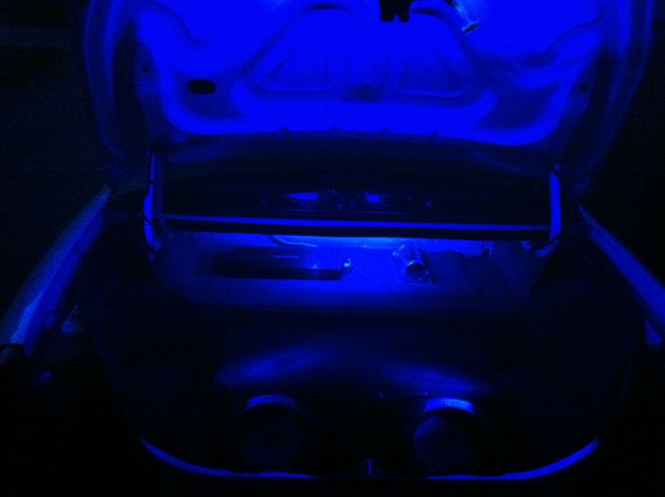 Open car trunk lit with blue LED lighting