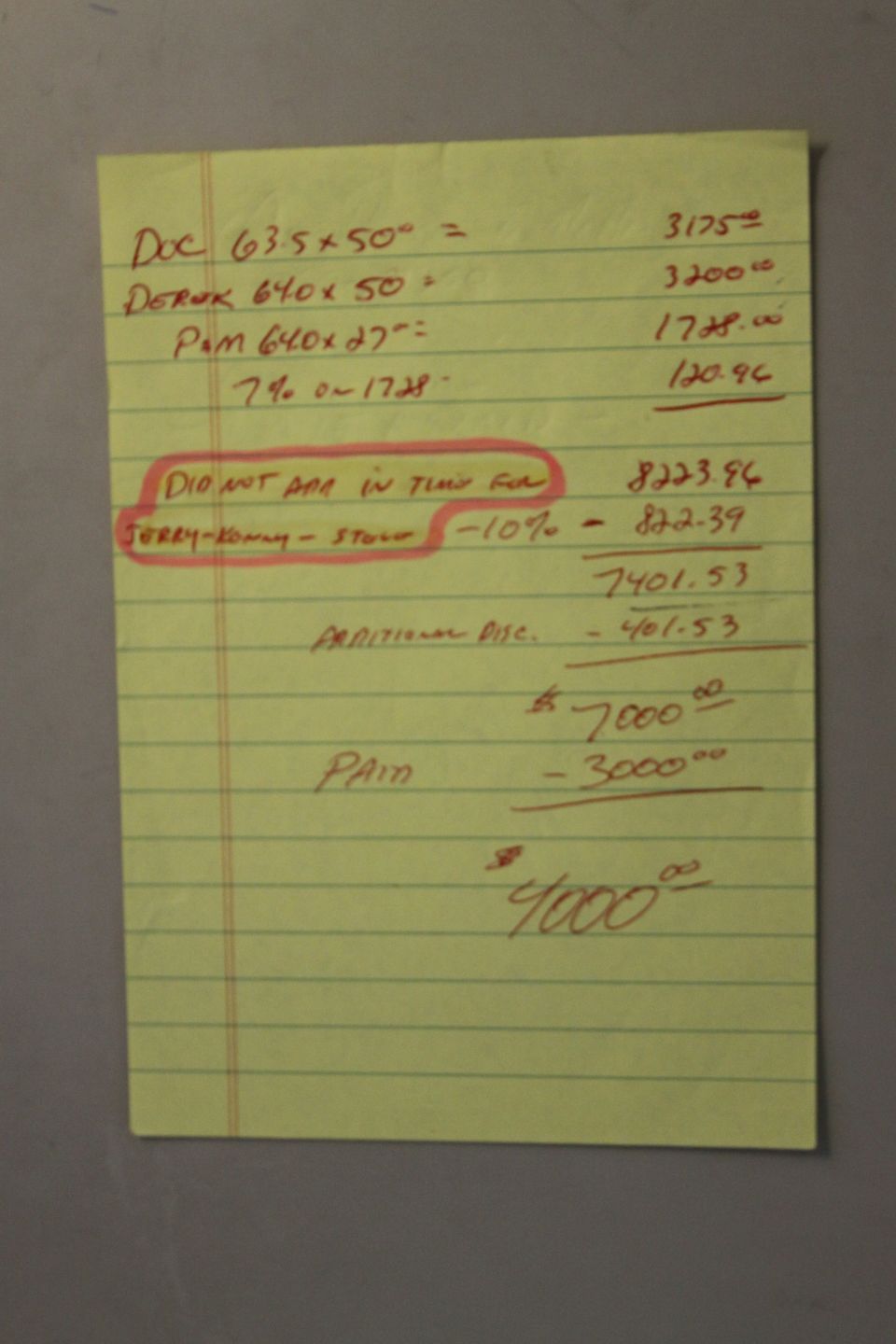 Yellow legal pad with handwritten calculations and notes, including a circled section