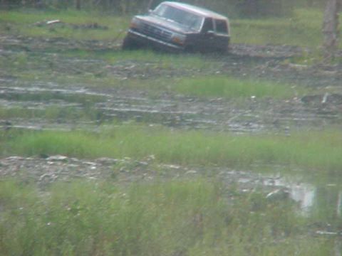 1996 Ford Bronco - Ford Bronco is stuck in the mud after driving off-road.