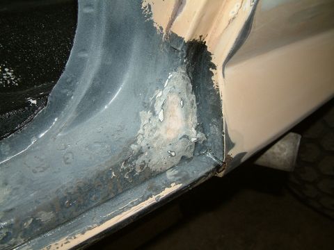 1983 Ford Bronco - This image shows significant rust damage and exposed metal on a vehicle's door frame, indicating a need for repair.