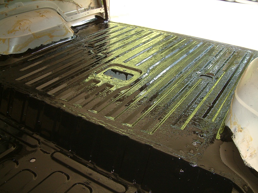 Interior cargo area of a 1983 Ford Bronco with black protective coating applied