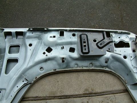 1983 Ford Bronco - Unpainted interior of a car door, revealing its internal construction and mounting hardware.