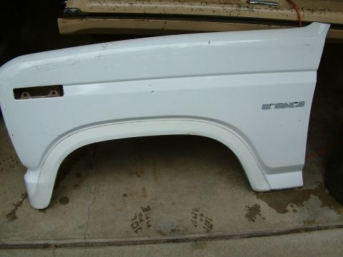 1983 Ford Bronco - A white fender with the Bronco nameplate is shown, likely a replacement part.