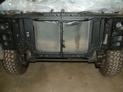 1983 Ford Bronco - Front view of a 1983 Ford Bronco, showing the radiator and large off-road tires.