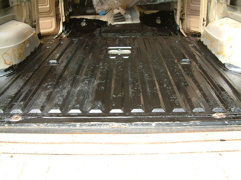 Interior floor of a vehicle with black protective coating applied