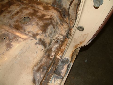 1983 Ford Bronco - Close-up of heavily rusted metal, possibly from the underside of a vehicle's hood or body panel.