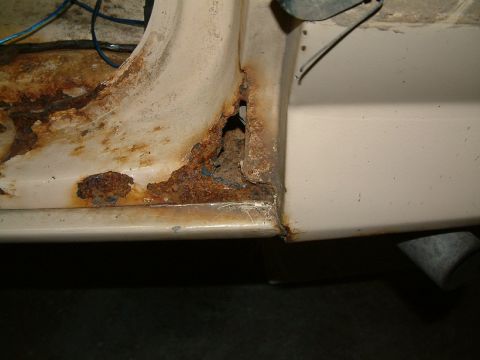 1983 Ford Bronco - Significant rust damage is visible on the door frame of this vehicle.