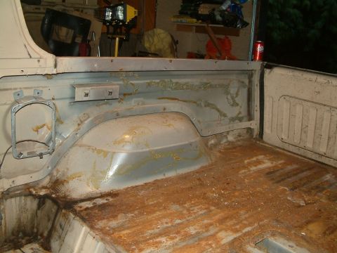 1983 Ford Bronco - The interior cargo area of a 1983 Ford Bronco shows significant rust and wear on the floor and bed panels.